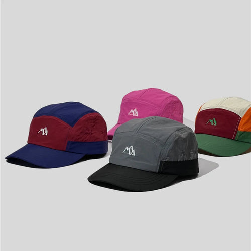 Nylon five panel caps arranged in magenta pink, retro multicolour, navy-burgundy and grey-black colourways