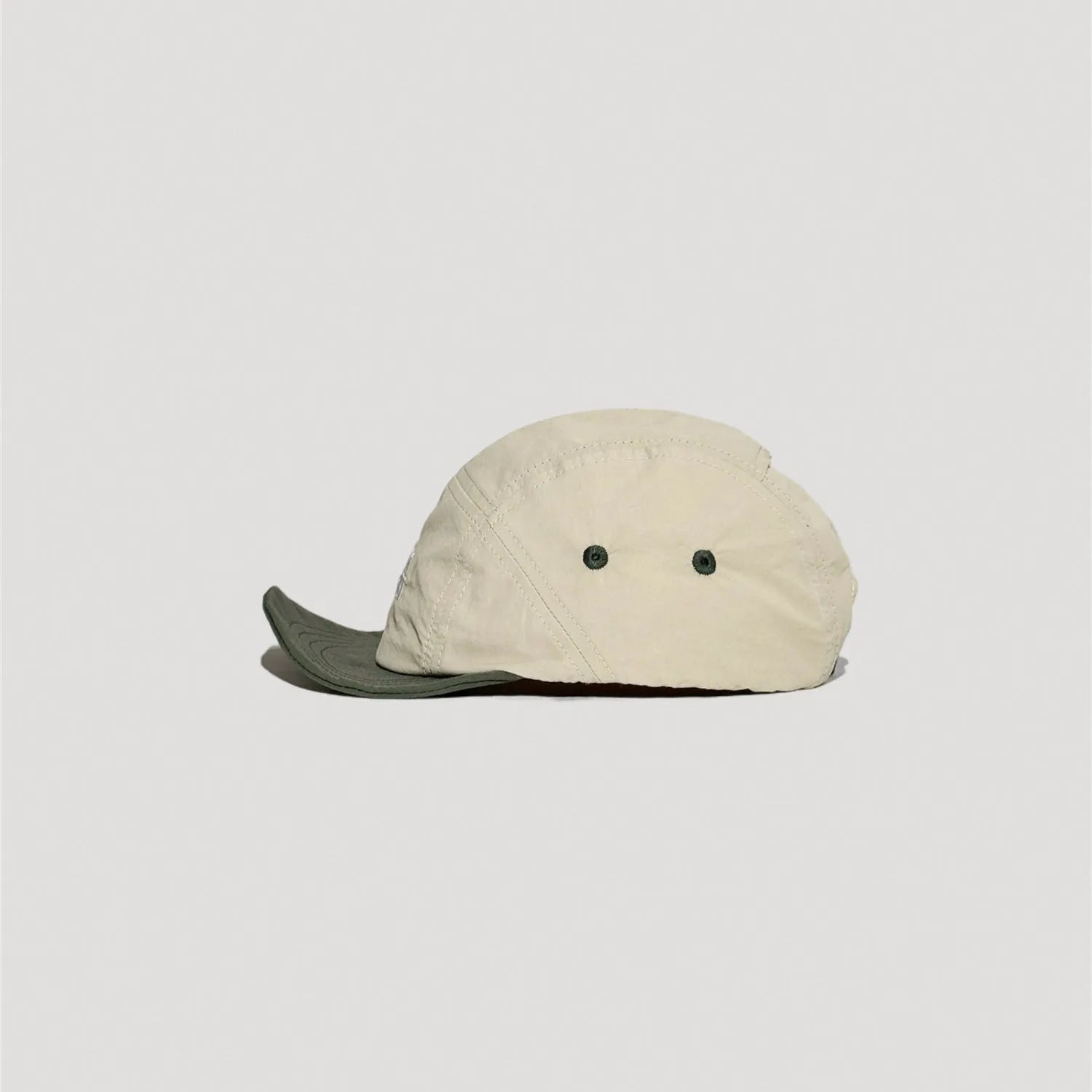Lightweight nylon camp cap featuring curved brim and clean stitched construction