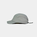 Nylon outdoor cap in light grey, side view showing two eyelets, curved seams and rear drawcord adjuster