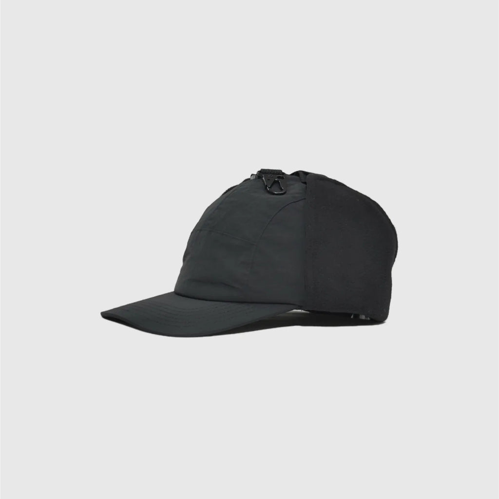 black winter baseball cap side view with folded fleece ear panel, curved peak and smooth nylon crown.
