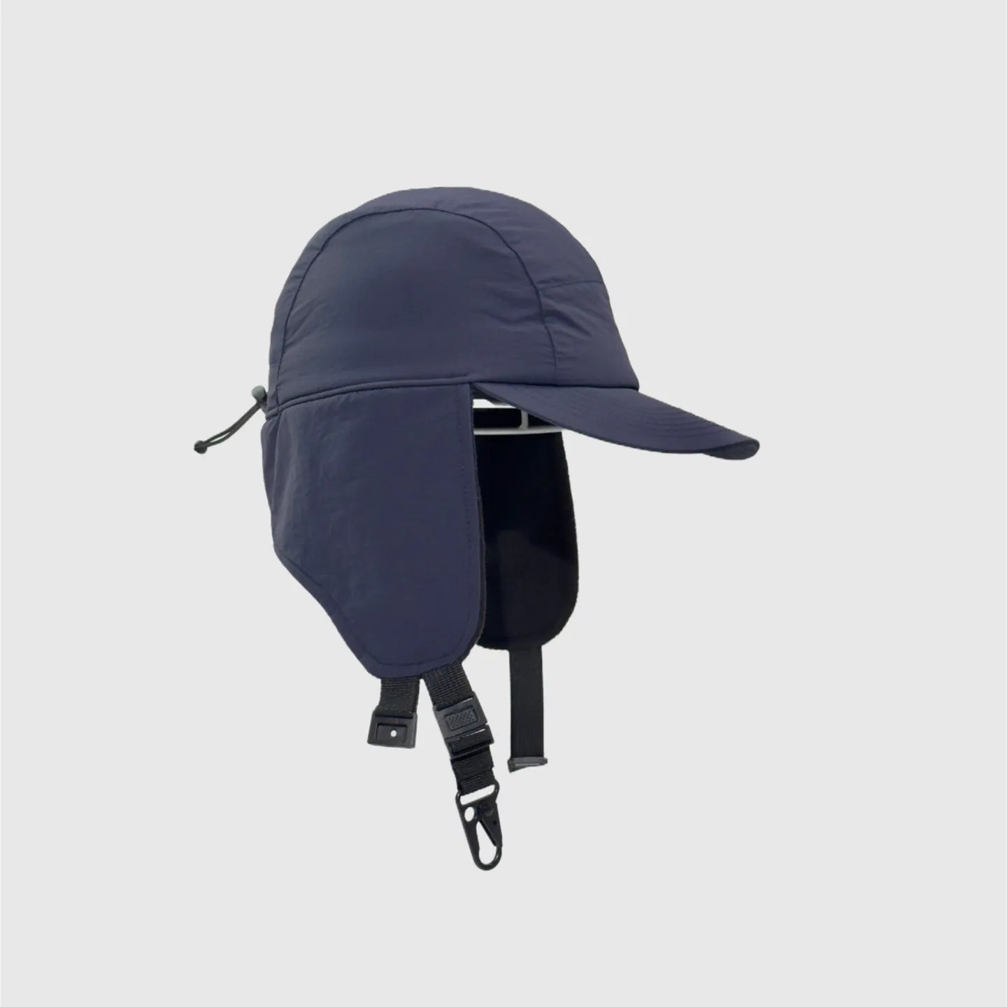 Navy nylon ear flap baseball cap side view with extended panels, curved brim and buckle straps.