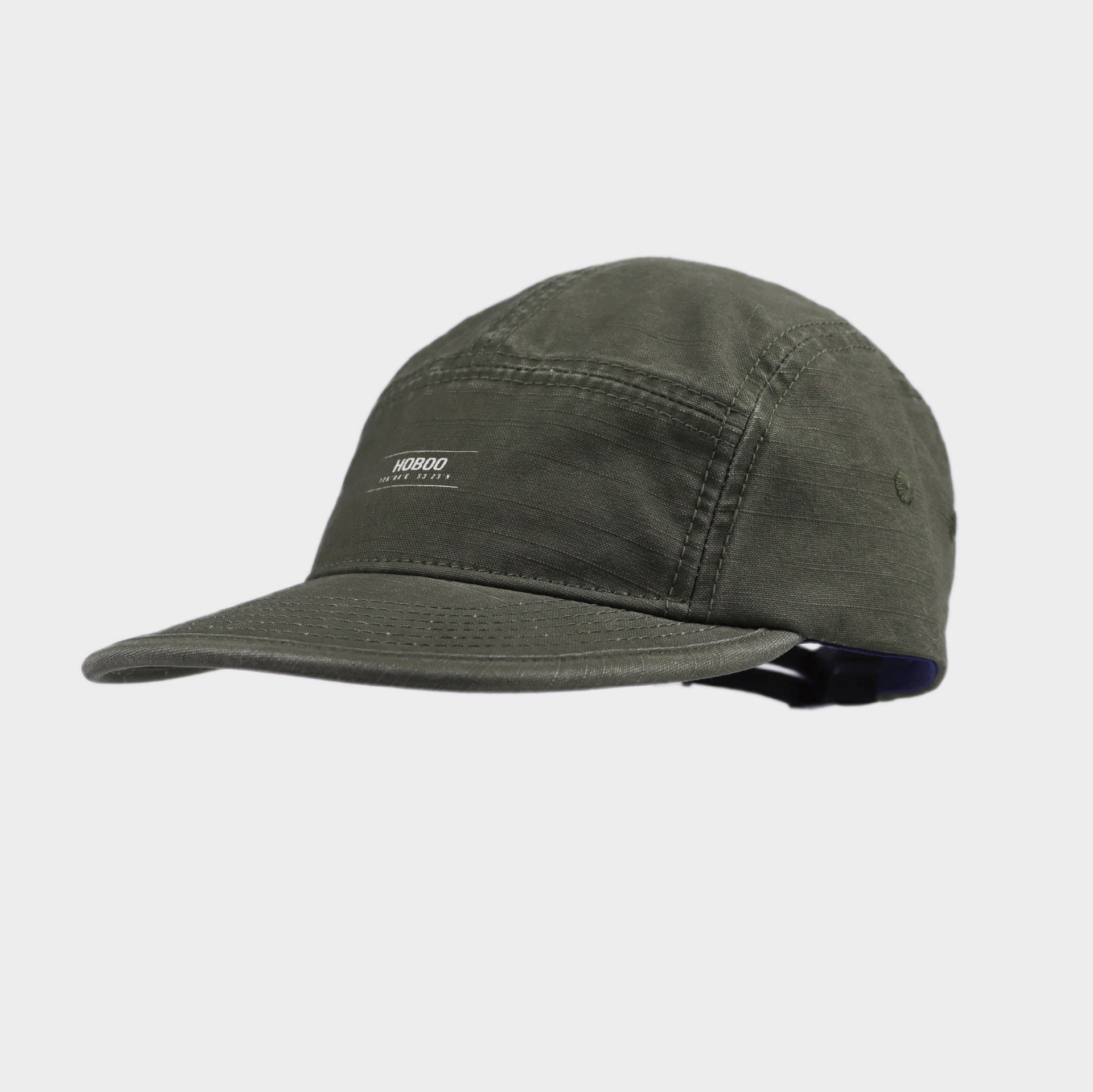 Olive green cotton 5 panel cap with a small front logo, stitched panel construction, curved brim and side eyelet