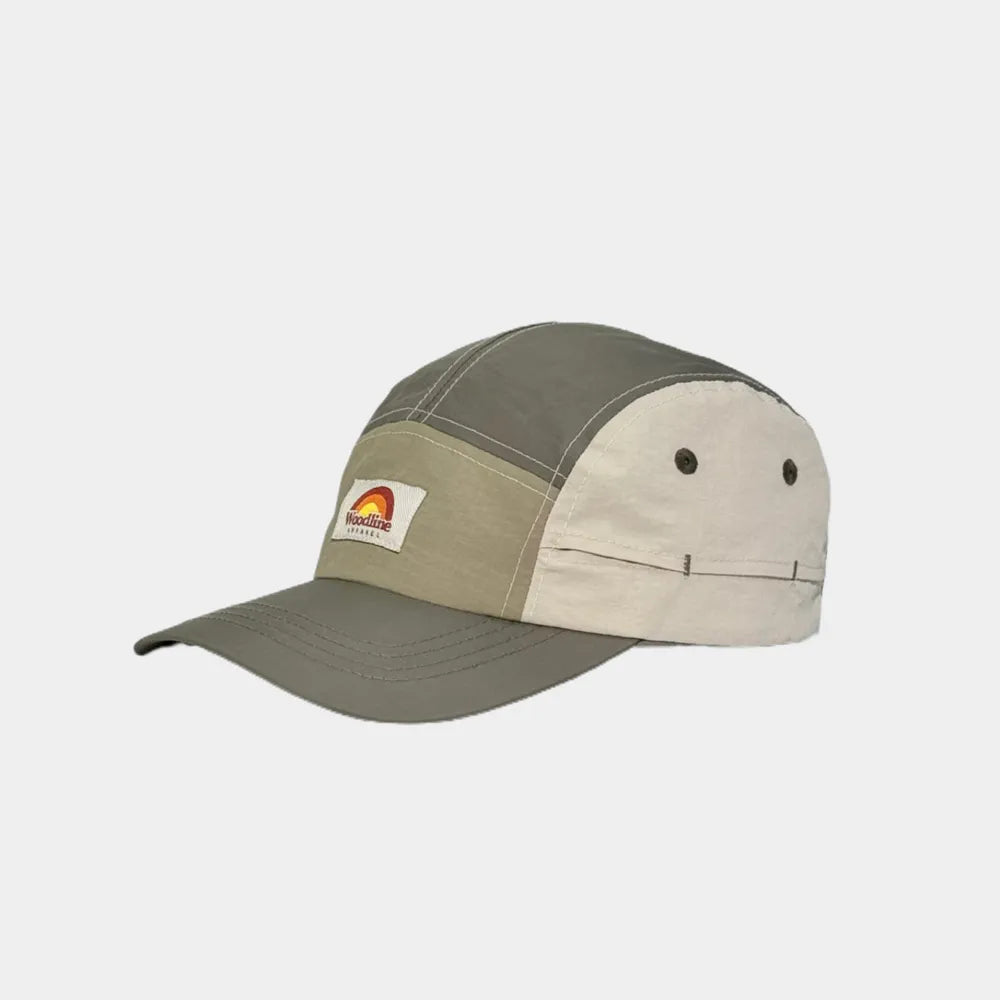Panelled camper cap in olive grey, khaki and cream, angled view with a woven badge and curved peak