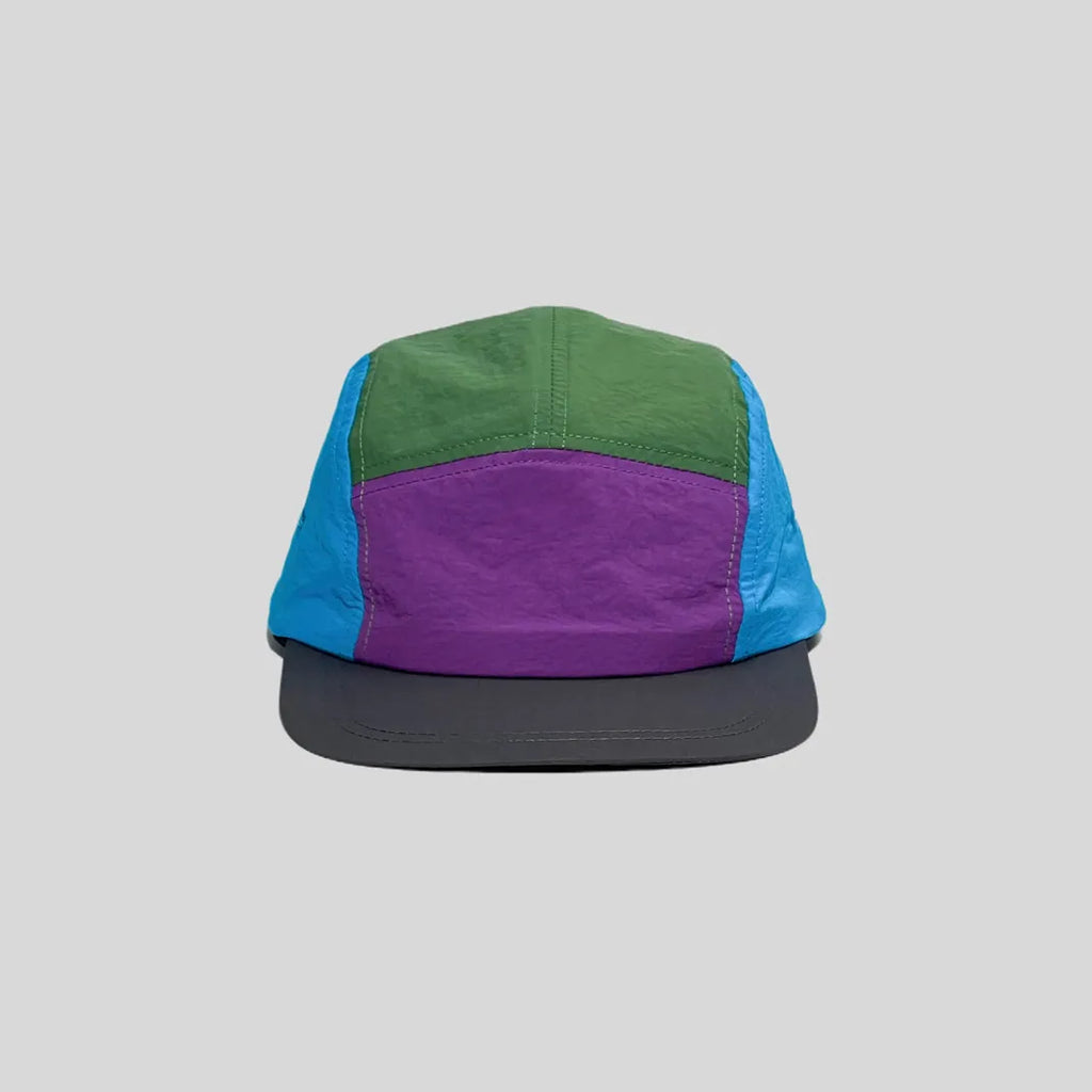 Quick-dry colour-block cap in green, purple and blue, front view showing the low crown and charcoal peak