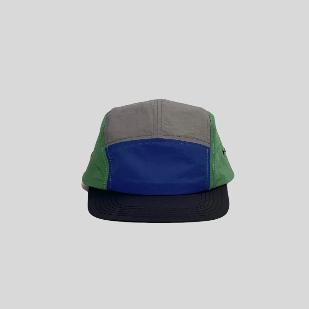 Quick-dry colour-block cap in grey, royal blue and green, front view showing the low crown and navy peak