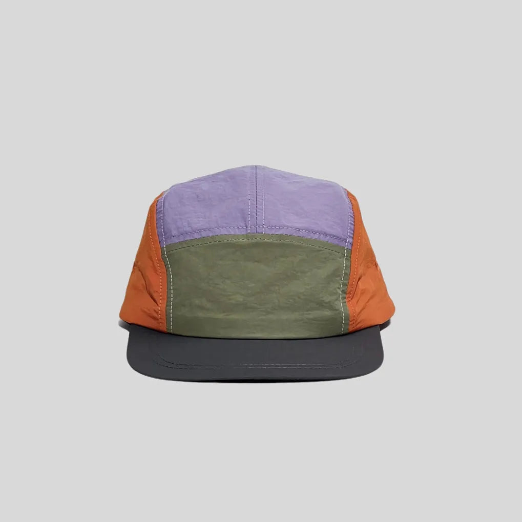 Quick-dry colour-block cap in lavender, olive and orange, front view showing the low crown and charcoal peak