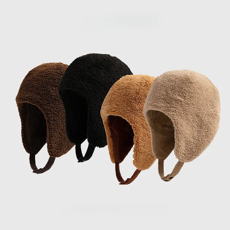 Teddy fleece trapper hats in dark brown, black, rust brown and beige, lined up to show the rounded ear-covering shape.