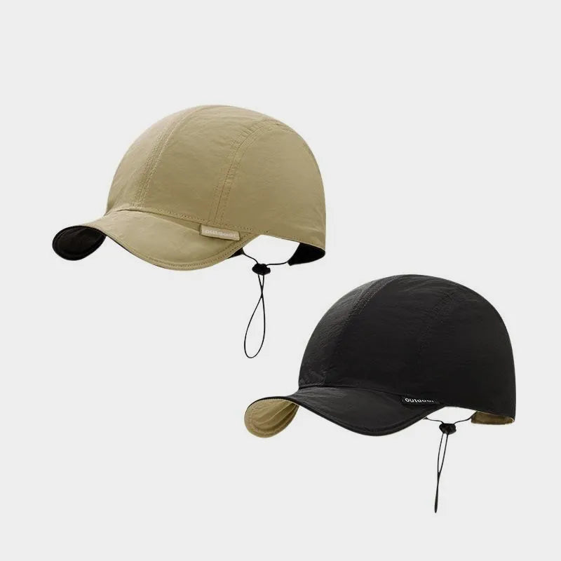 Beige and black reversible nylon cap shown from both colour sides, with a short curved peak and rear toggle.