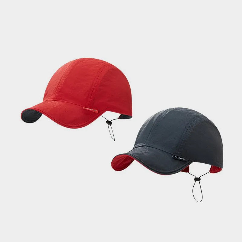Red and charcoal grey reversible nylon cap shown from both colour sides, with a short curved peak and rear toggle.