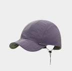 Dusty lilac short peak cap shown front-on, with a smooth crinkled finish, rounded crown and neat twin seams.