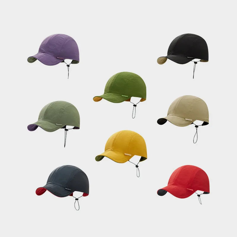 Reversible short peak cap range showing dusty lilac, sage green, black, beige, mustard, olive, charcoal and red options.