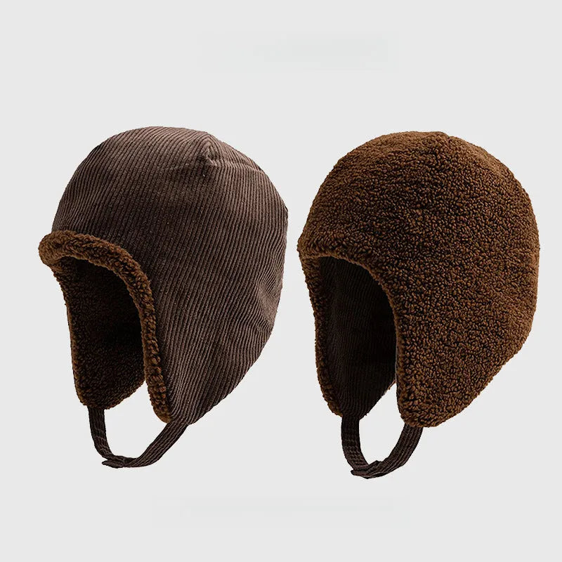 Dark brown reversible trapper hat shown with corduroy and teddy fleece sides, ear flaps and press-stud straps.