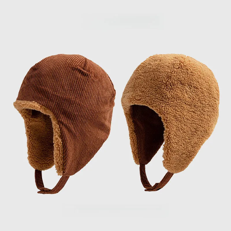 Rust brown reversible trapper hat shown with corduroy and teddy fleece sides, ear flaps and press-stud straps.