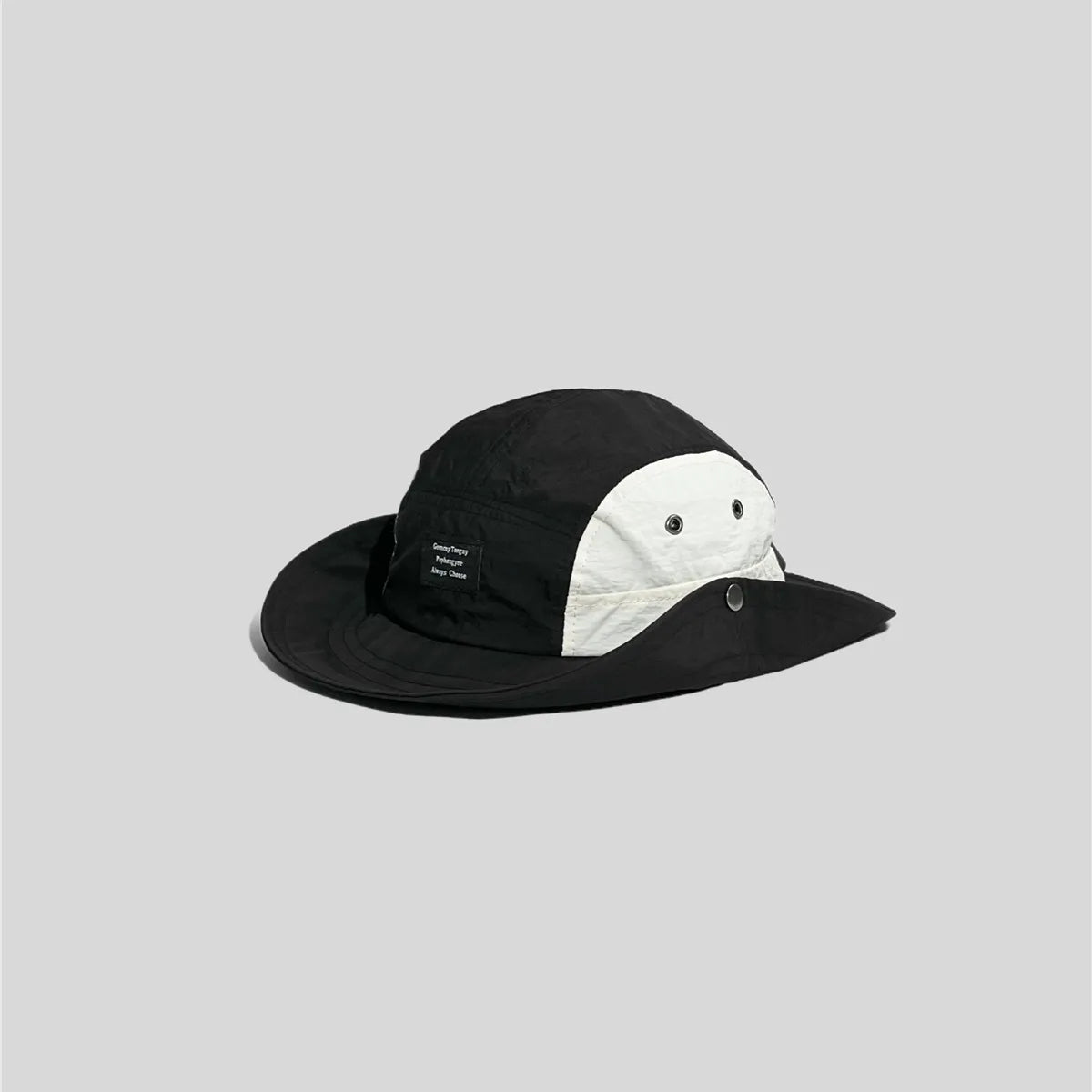 Black snap-side safari hat in a three-quarter view, with white eyelet panels and one brim edge fastened up.