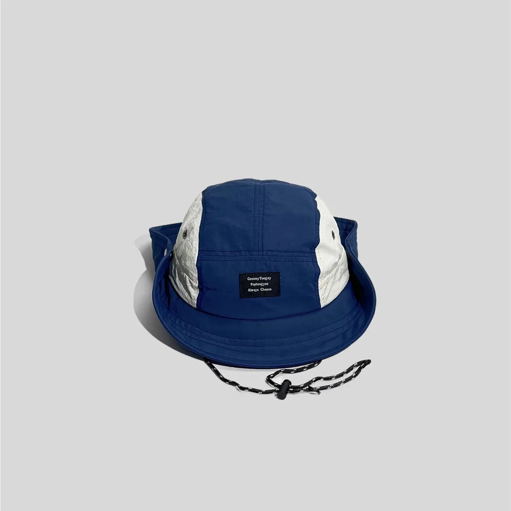Royal blue snap-up boonie hat with white eyelet panels, raised brim sides, front patch and black chin cord.