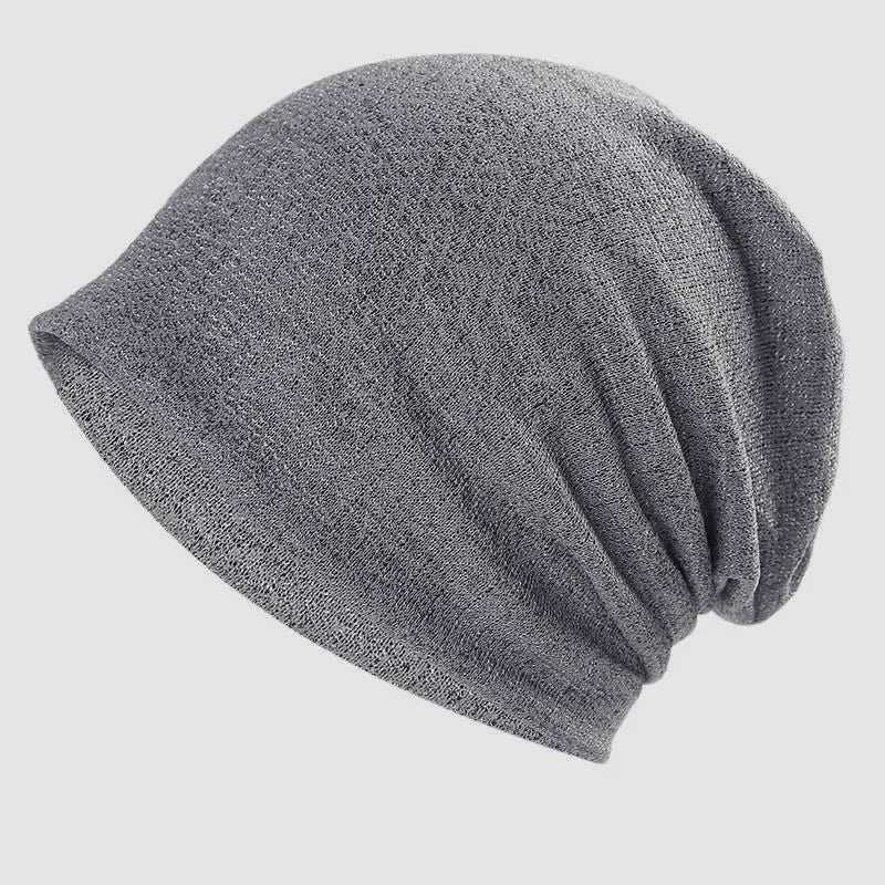 Grey textured slouchy beanie with gentle rear folds and a streamlined edge for a simple contemporary look.