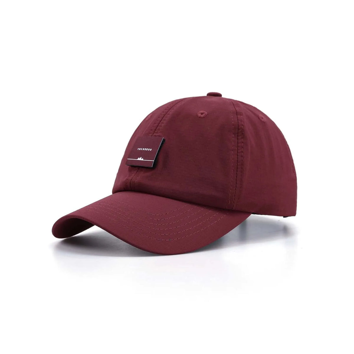 Unstructured baseball cap in burgundy, angled front view with a curved peak and square woven label