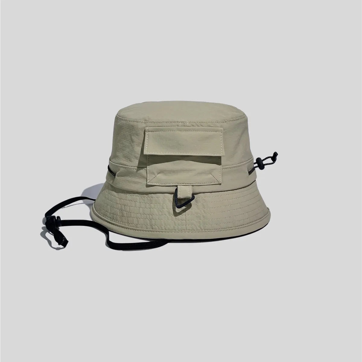 Utility bucket hat in khaki green, side view showing the flap pocket, D-ring loop and adjustable crown cord