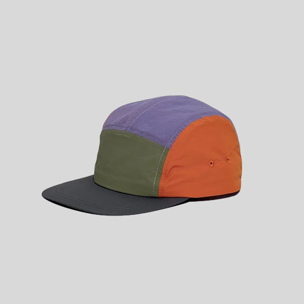 Waterproof 5-panel cap in lavender, olive and orange, side view with colour-block panels, twin eyelets and charcoal peak