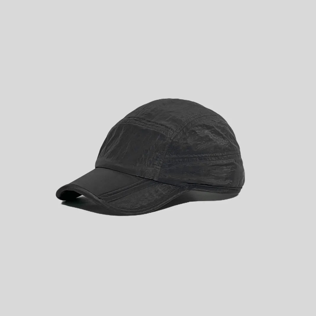 Waterproof running cap in black, angled side view showing the panelled crown, glossy texture and curved peak