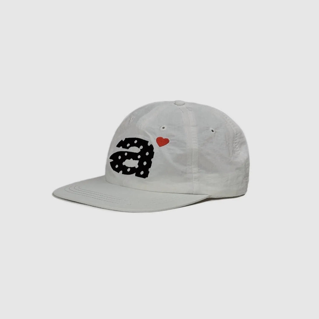 White 5 panel cap side view with clean nylon texture and embroidered decoration