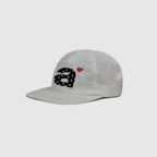 White 5 panel cap side view with clean nylon texture and embroidered decoration