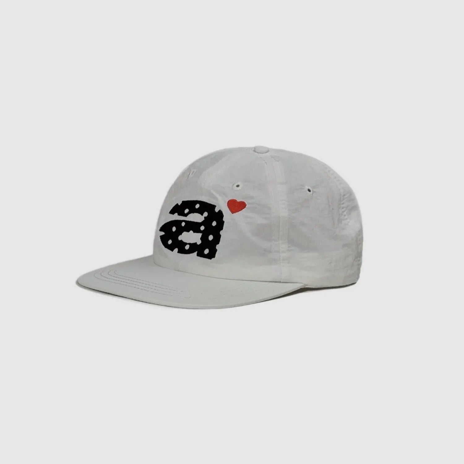 White 5 panel cap side view with clean nylon texture and embroidered decoration