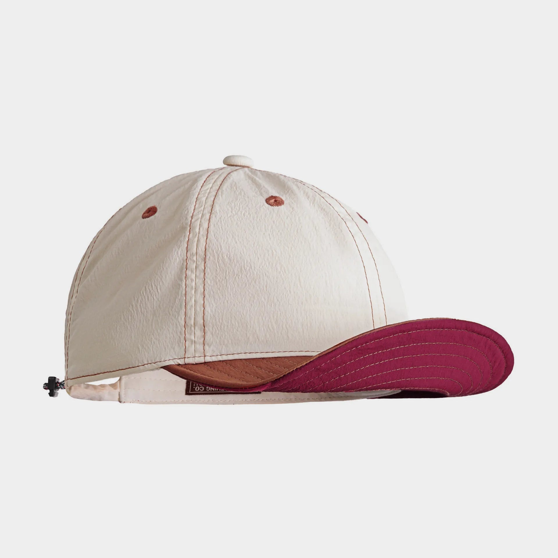 White baseball cap with colourful contrast brim and embroidered sports inspired details