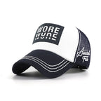 White and navy mesh trucker cap with a black WORE front graphic, curved brim, white contrast stitching and side embroidery.