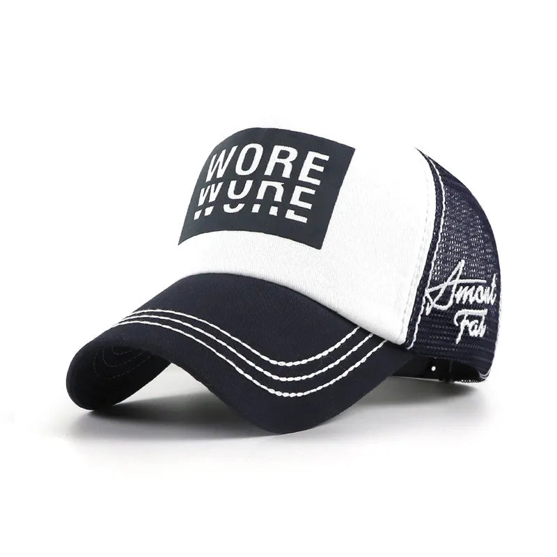 White and navy mesh trucker cap with a black WORE front graphic, curved brim, white contrast stitching and side embroidery.