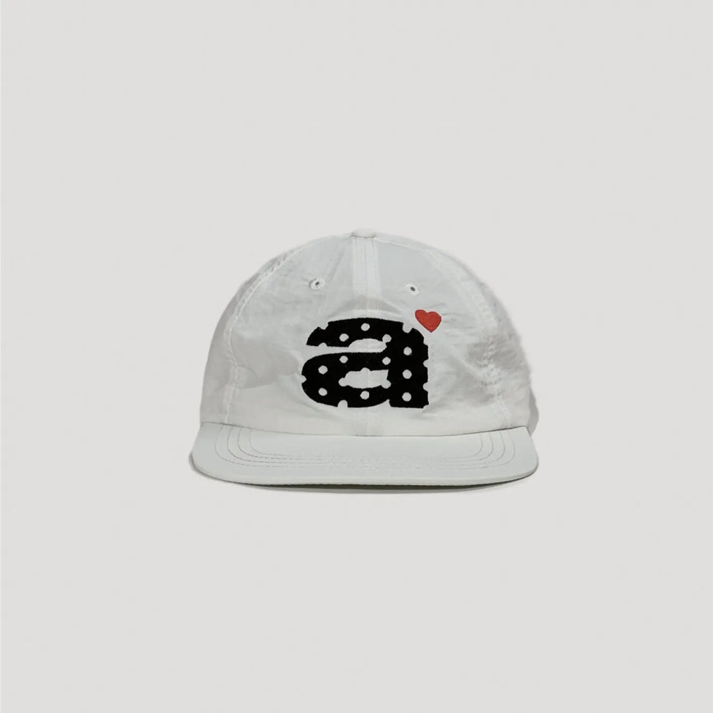 White nylon camp cap featuring bold embroidered graphic and minimalist streetwear look