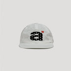 White nylon camp cap featuring bold embroidered graphic and minimalist streetwear look