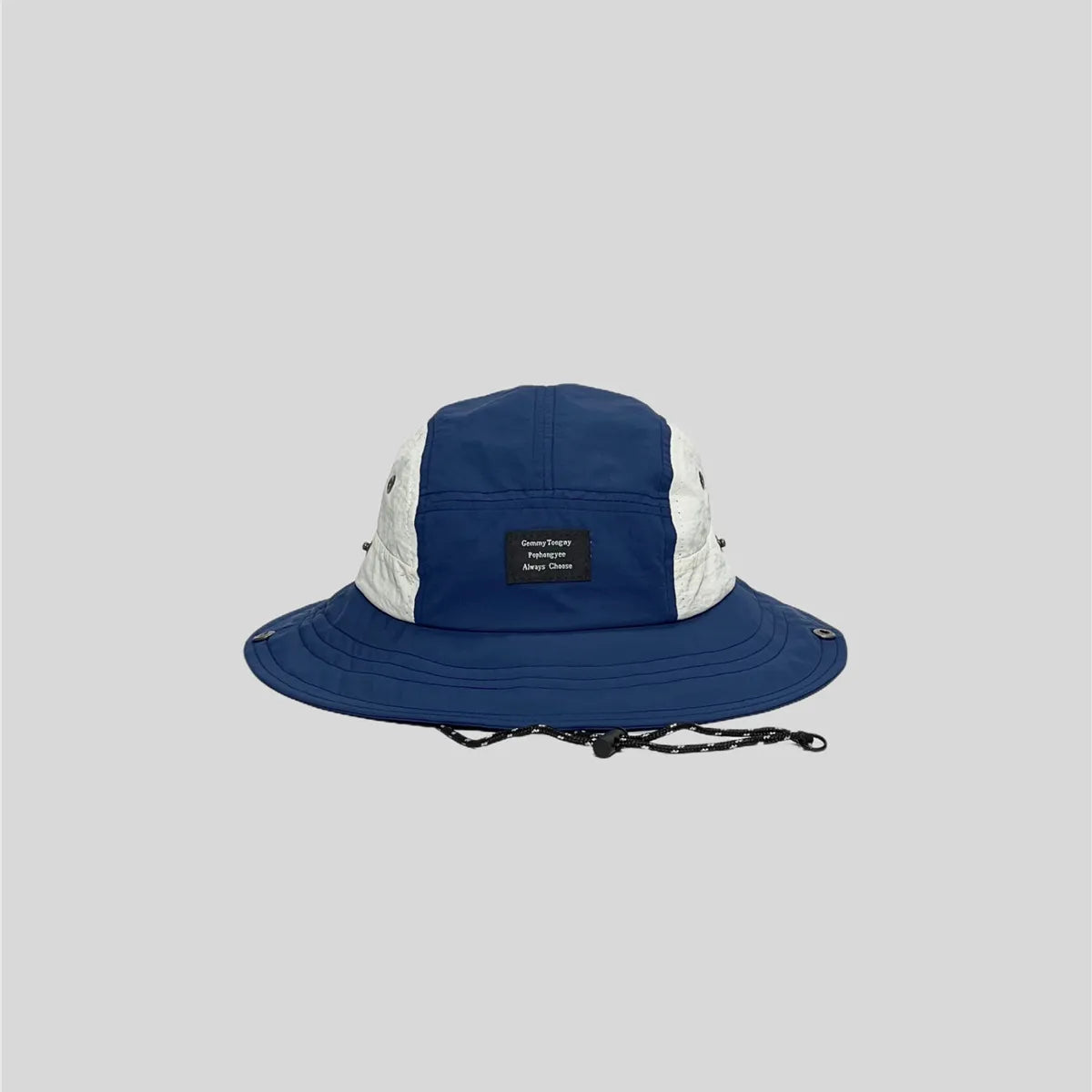 Royal blue wide-brim sun hat with white side panels, front patch label, stitched brim and metal snap fasteners.