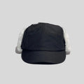 Winter baseball cap with ear flaps in black, front view with a panelled crown, curved peak and white plush trim
