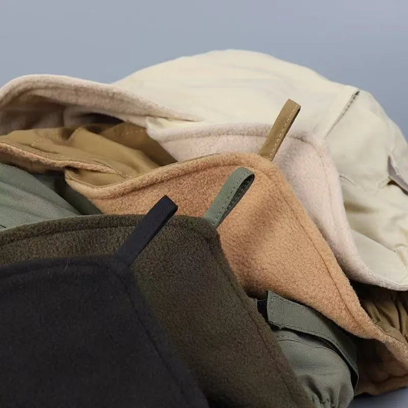 Winter ear flap cap colour options shown in stacked shades including black, olive, khaki and cream.