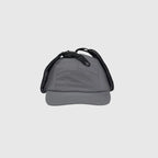 Grey winter ear flap cap front view with folded side panels, curved brim and top fastening clips.