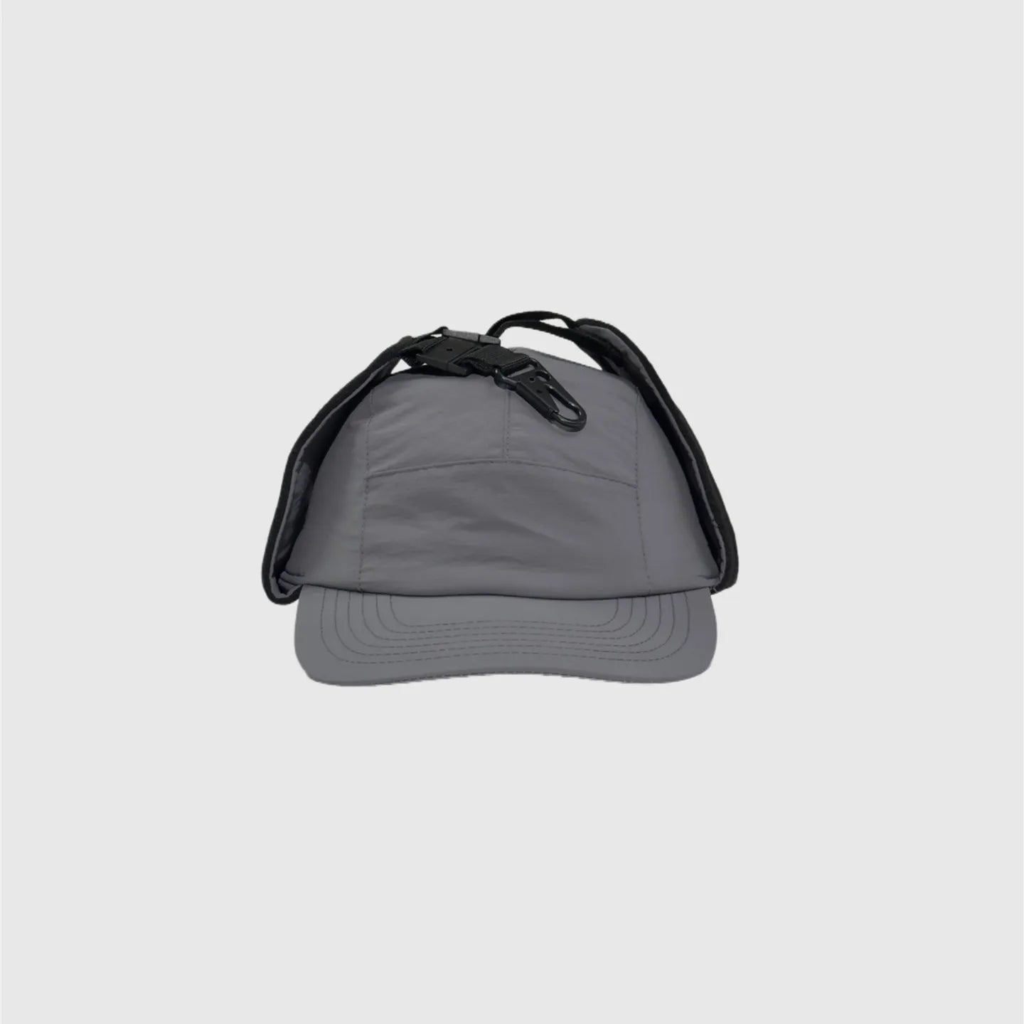 Grey winter ear flap cap front view with folded side panels, curved brim and top fastening clips.