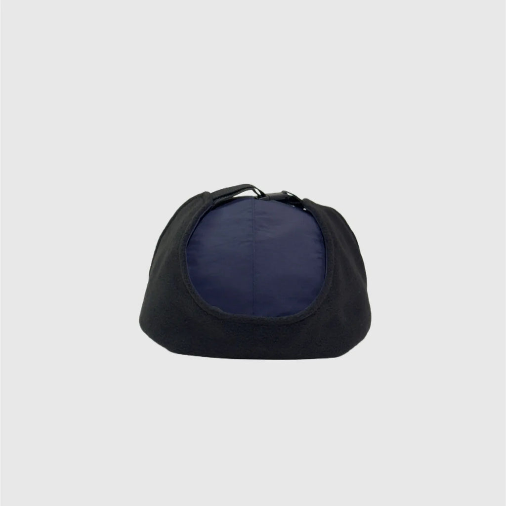 Navy winter ear flap cap top view with black fleece side panels folded over the crown.