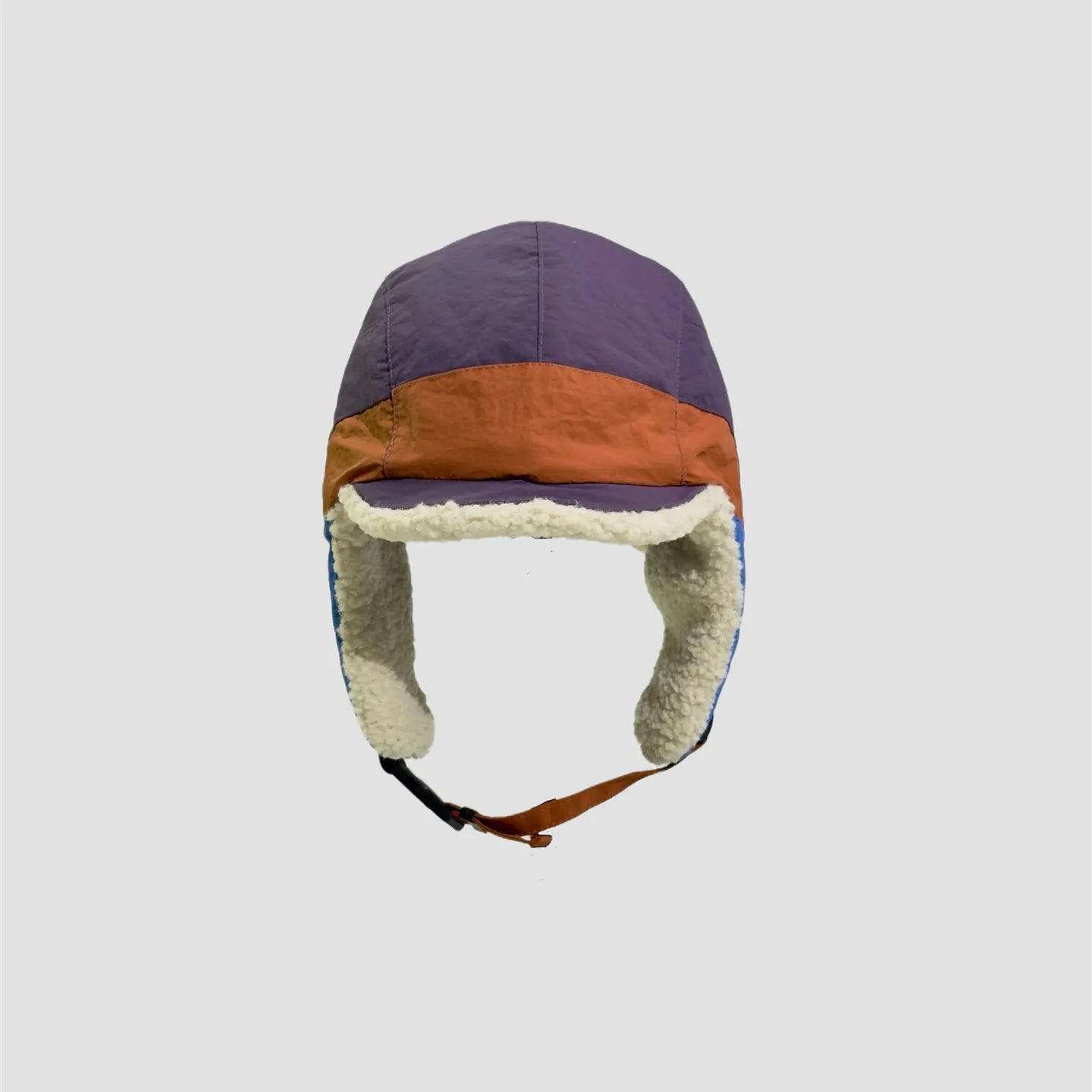 Purple and orange winter trapper cap front view with cream fleece lining, short peak and ear coverage.